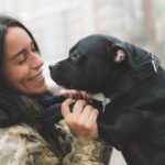 girl in military uniform and her dog