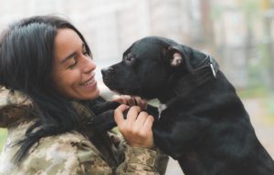 girl in military uniform and her dog