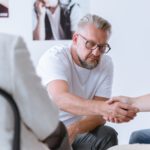 Men shaking hands during psychotherapy for people with addictions